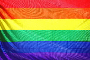 Close-up of a colorful rainbow flag symbolizing LGBT pride and diversity. HD wallpaper