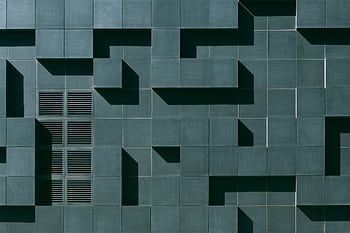 Abstract geometric facade in Oslo with tiles, grids, and shadows creating a minimalist design. HD wallpaper