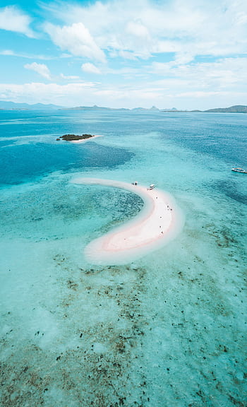 A stunning aerial view of a pink beach surrounded by turquoise waters in East Nusa Tenggara, Indonesia. HD phone wallpaper
