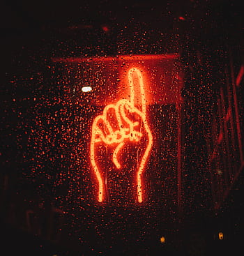 A vibrant neon hand sign seen through a wet window, creating a dramatic urban night scene. HD phone wallpaper