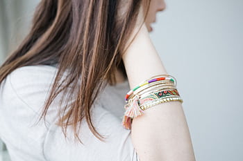 Elegant bracelets on a woman's arm showcasing vibrant accessory fashion. HD wallpaper