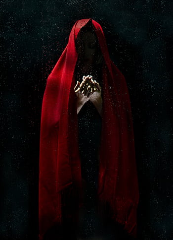 A mysterious woman in a red cloak stands against a dark, eerie background, creating a spooky atmosphere. HD phone wallpaper
