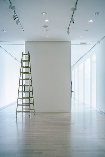 Wide indoor space with a ladder, showcasing LED lighting and modern minimalism. HD phone wallpaper