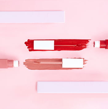 Top view of artistic makeup flatlay showcasing smeared lip gloss on a pink background. HD phone wallpaper