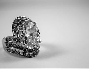 Close-up of a luxurious diamond ring showcasing intricate design and elegance. HD wallpaper