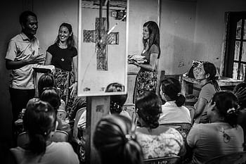 A diverse group of people gather in a room for an educational seminar. HD wallpaper