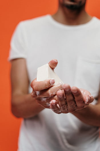 Close-up of a man washing hands with bar soap, promoting hygiene and cleanliness. HD phone wallpaper