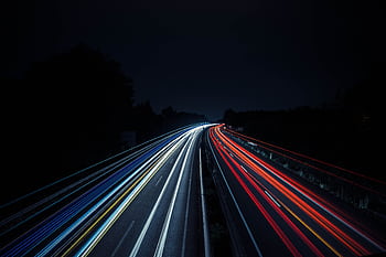 Long exposure of vibrant light trails on a highway at night in Osnabrück, Germany. HD wallpaper