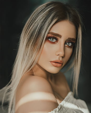 Elegant portrait of a woman with blonde hair and striking blue eyes, highlighting natural beauty. HD phone wallpaper