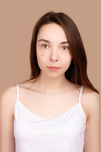 A front-facing portrait of a young woman with natural skin and minimal makeup. HD phone wallpaper
