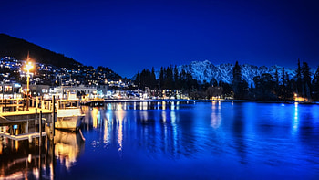 lakeside town on a blue night, night, blue, town, boats, mountains, docks, lake HD wallpaper