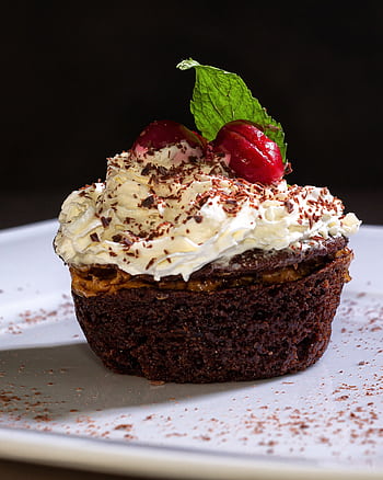Indulgent chocolate cupcake topped with whipped cream and cherry garnish. HD phone wallpaper