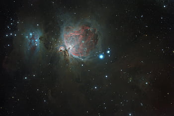 A captivating of the Orion Nebula, showcasing celestial beauty and the vastness of outer space. HD wallpaper