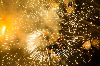 Colorful fireworks bursting in celebration during a vibrant night festival. HD wallpaper