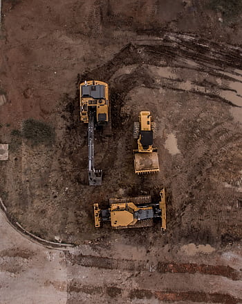 An aerial shot of heavy machinery at a construction site, including excavators and road rollers. HD phone wallpaper