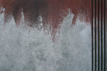 Close-up of a textured wall with abstract paint strokes and vertical stripes, showcasing concrete surfaces. HD wallpaper