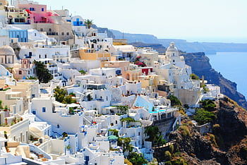 Breathtaking view of Santorini's iconic white and blue architecture against the Aegean Sea. HD wallpaper