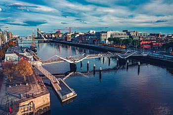 Stunning aerial view of Dublin cityscape featuring the river, modern architecture, and bridges. HD wallpaper