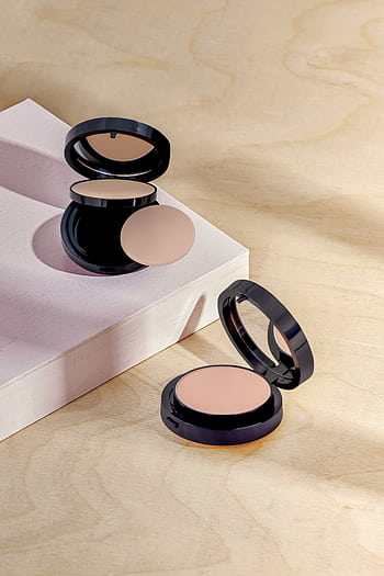 Open makeup compacts on a textured surface with soft lighting. HD phone wallpaper