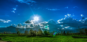 Scenic view of Kalam's green fields and dramatic sky under bright sunlight. HD wallpaper