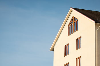 Minimalist modern residential building facade against clear blue sky. HD wallpaper