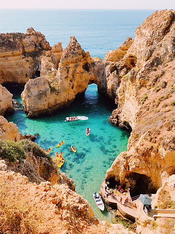 Stunning aerial view of cliffs and clear blue water at Lagos, Portugal, showcasing natural beauty. HD phone wallpaper