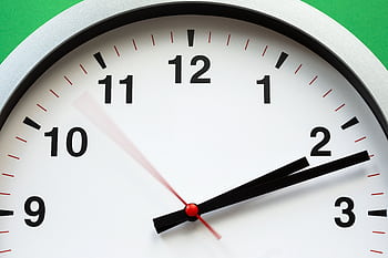 A close-up of an analog clock face showing time with blurred motion HD wallpaper