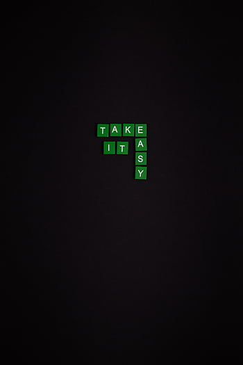 Motivational minimalist quote 'Take it Easy' on black background with green text tiles. HD phone wallpaper