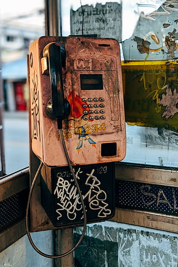 A retro booth with graffiti and urban decay creating a nostalgic vibe. HD phone wallpaper