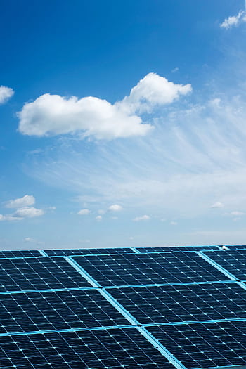 Solar panels under a clear blue sky, symbolizing renewable energy and sustainability. HD phone wallpaper
