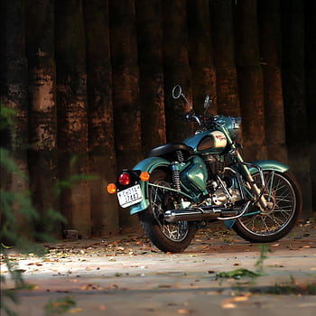 A classic retro motorcycle parked in a serene outdoor setting, exuding vintage charm and style. HD phone wallpaper