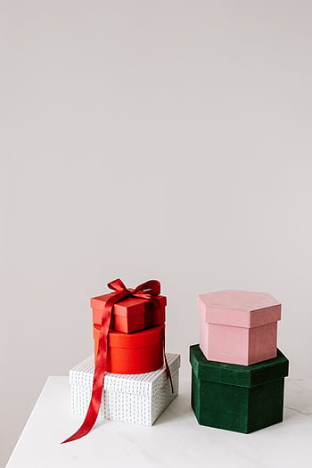 Stylish colorful gift boxes arranged on a minimalist white surface, perfect for celebrations. HD phone wallpaper