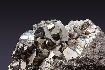 Close-up of sparkling pyrite crystals showcasing their metallic luster. HD wallpaper