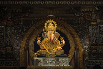 A beautifully decorated idol of Lord Ganesh, showcasing traditional Hindu art and cultural heritage. Captured in Pune, India. HD wallpaper