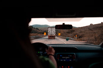 Scenic drive with a truck on a highway surrounded by hills. Perfect for travel themes. HD wallpaper