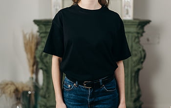 Casual fashion style featuring a black T-shirt paired with blue jeans, perfect for everyday wear. HD wallpaper