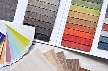 Colorful fabric and paint swatches laid out for design inspiration and material selection. HD wallpaper