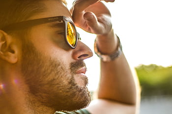 Close-up of a bearded man wearing sunglasses, enjoying a sunny day outdoors. HD wallpaper
