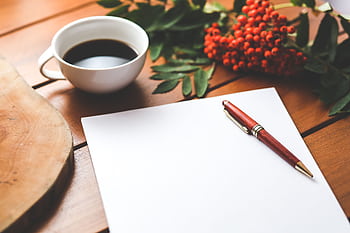 Empty paper sheet with pen and coffee next to red berries, ideal for design workspace concepts. HD wallpaper
