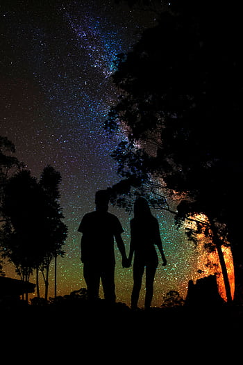 A couple's silhouette under a vibrant starry sky in São Paulo. HD phone wallpaper