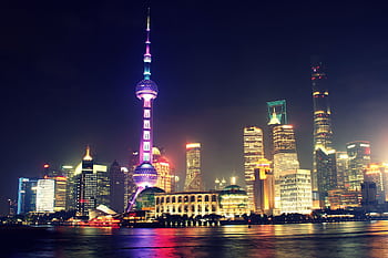 Vibrant nighttime view of Shanghai's iconic skyline featuring the illuminated Oriental Pearl Tower. HD wallpaper