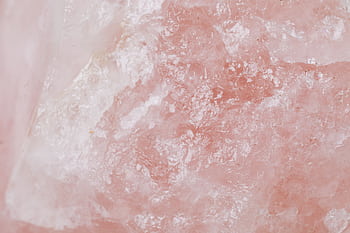 Detailed view of rose quartz showcasing its pink crystalline texture and natural patterns. HD wallpaper