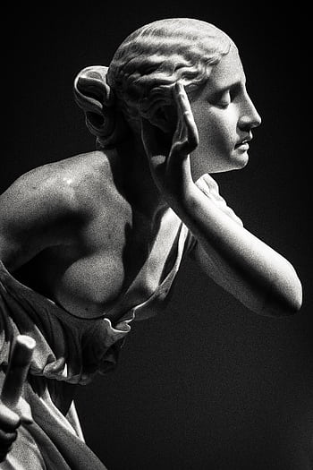 Graceful marble statue of a woman, capturing an artistic moment indoors. HD phone wallpaper
