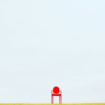 A solitary red chair on a sandy beach under a vast sky in Władysławowo, Poland. Minimalist design. HD phone wallpaper