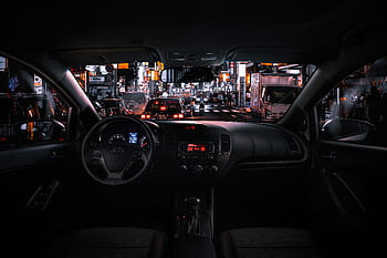 View from car interior at night in Tokyo, featuring bustling street traffic and illuminated cityscape. HD wallpaper