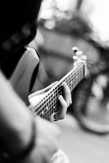 Close-up of a guitarist's hands on the fretboard in black and white. HD phone wallpaper