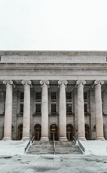 Majestic courthouse facade with columns and stairs blanketed in snow, capturing Denver's winter charm. HD phone wallpaper