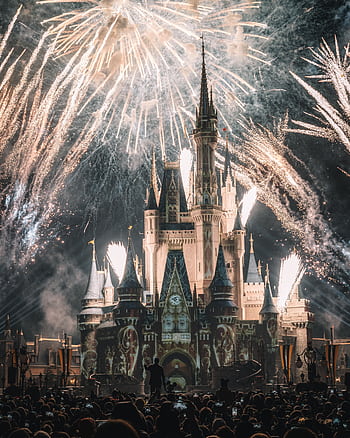 Enchanting night view of a famous castle illuminated by spectacular fireworks, capturing a magical ambiance. HD phone wallpaper