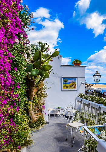 Charming Mediterranean balcony adorned with vibrant bougainvillea, overlooking sea. HD phone wallpaper