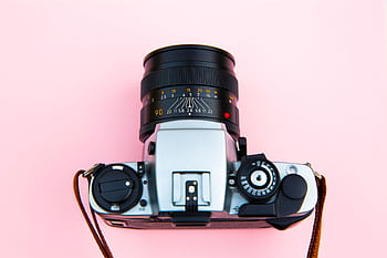 A classic analog camera with a lens on a vibrant pink background. HD wallpaper